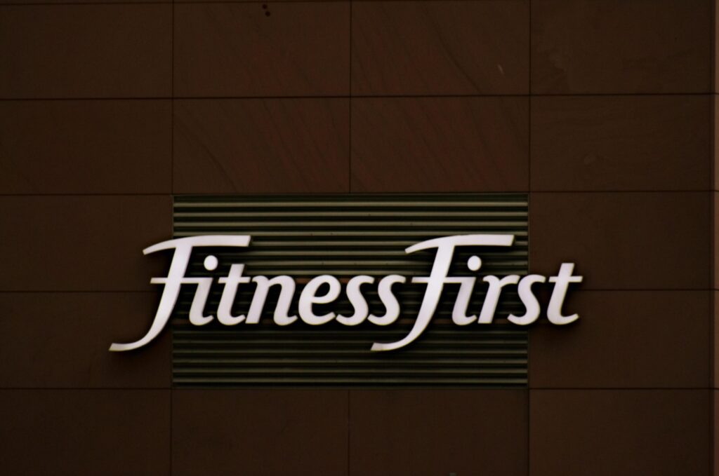 pexels photo 1769735 1769735 Close-up of FitnessFirst gym sign on a contemporary brown wall.